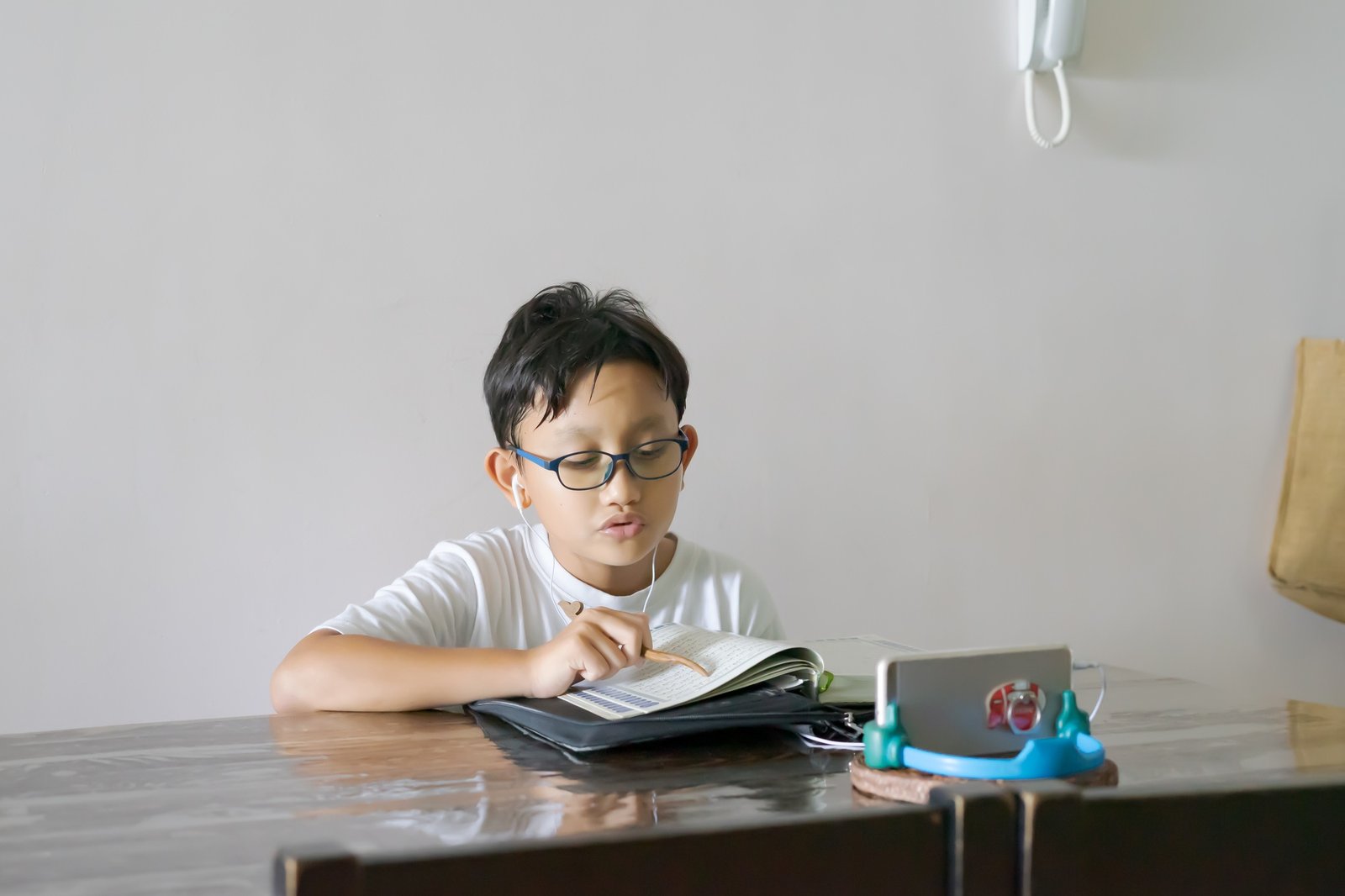 asian-kid-reading-al-quran-through-video-call-using-smartphone-during-education-and-learning-from-ho-1
